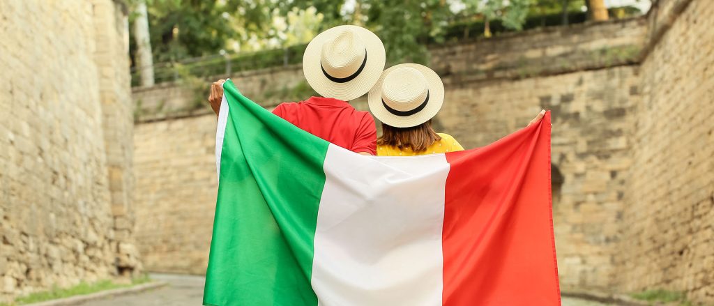 Young,Couple,With,Italian,Flag,Outdoors,,Back,View