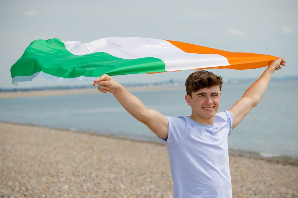 Young,Adult,Caucasian,Male,Holding,On,A,Beach,Holding,The